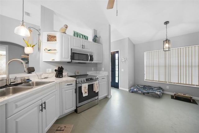 kitchen featuring white cabinetry, sink, hanging light fixtures, and appliances with stainless steel finishes