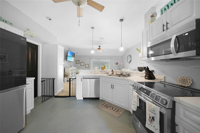 kitchen with white cabinets, sink, hanging light fixtures, ceiling fan, and stainless steel appliances