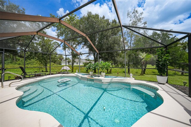 view of pool with a lanai, an in ground hot tub, and a patio