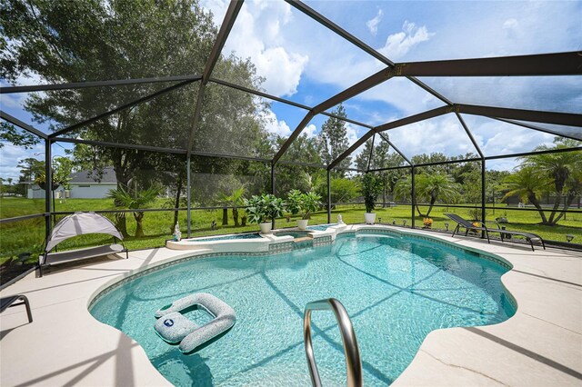 view of pool featuring glass enclosure, a patio area, and a yard