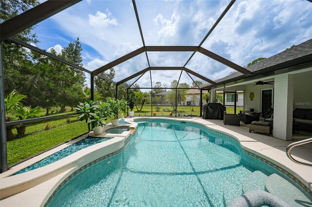 view of pool featuring a patio, an outdoor hangout area, ceiling fan, and a lanai