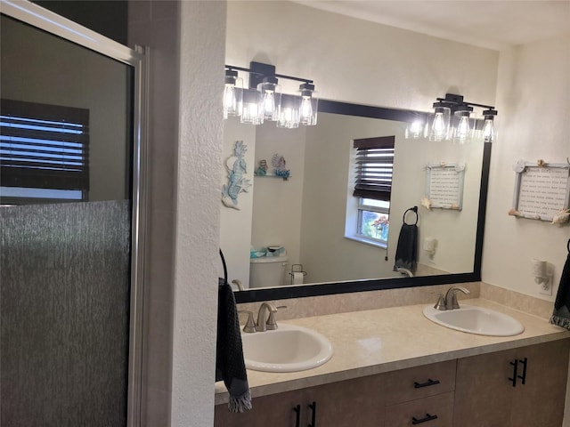 bathroom with vanity, toilet, and walk in shower