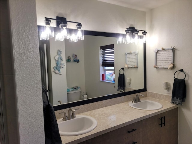 bathroom featuring vanity and toilet