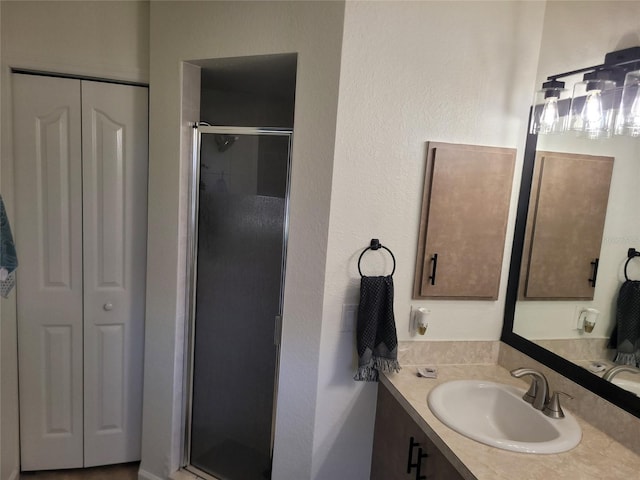 bathroom with vanity and a shower with door