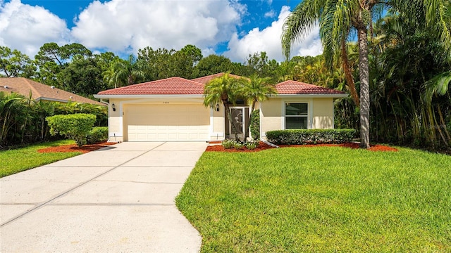 mediterranean / spanish house featuring a garage and a front yard