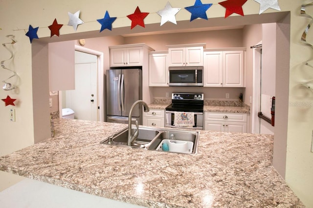 kitchen featuring sink, white cabinetry, and appliances with stainless steel finishes