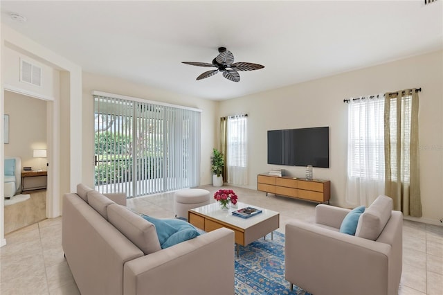 tiled living room featuring plenty of natural light and ceiling fan