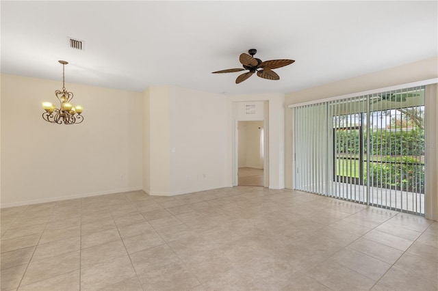 tiled empty room with ceiling fan with notable chandelier