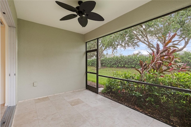 unfurnished sunroom featuring ceiling fan