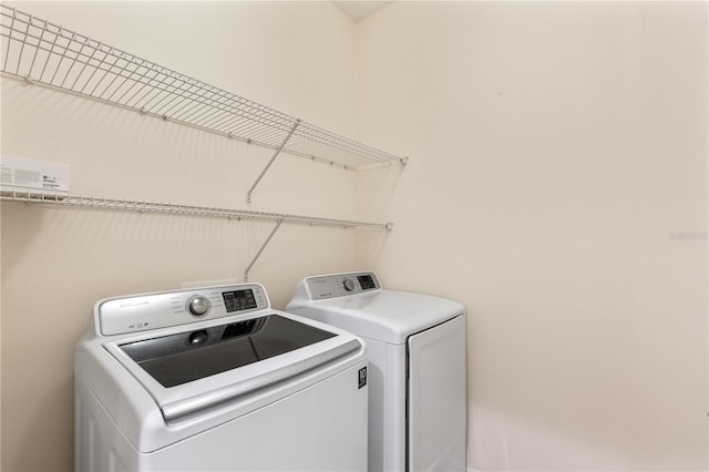 clothes washing area featuring washing machine and clothes dryer