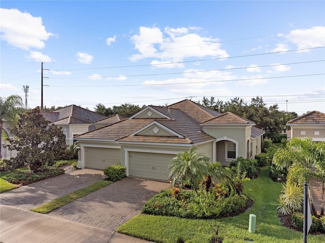 view of front facade with a front yard and a garage