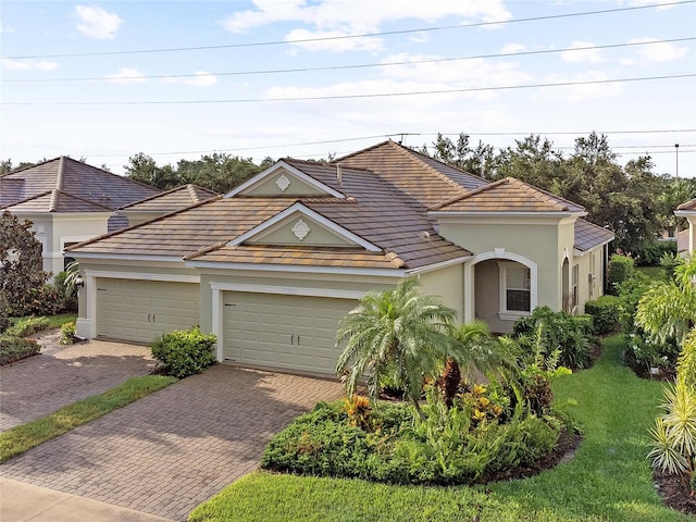 view of front of property with a front yard and a garage