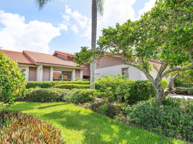 mediterranean / spanish-style home featuring a front lawn