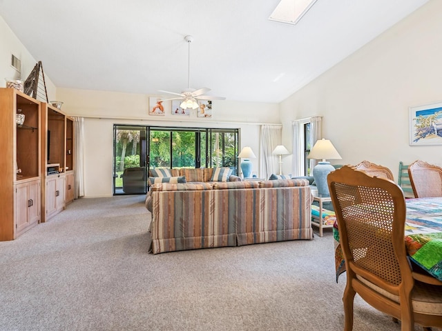 interior space with vaulted ceiling, ceiling fan, and carpet