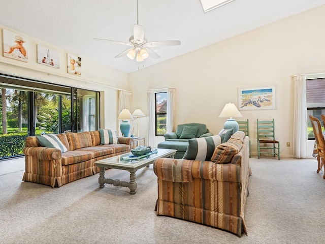 carpeted living room with plenty of natural light, ceiling fan, and vaulted ceiling