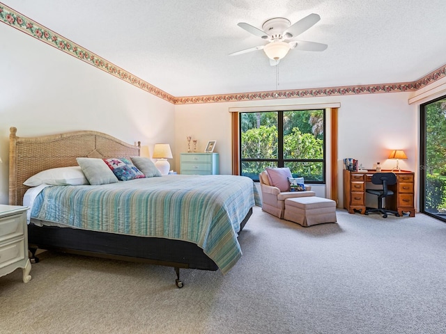 bedroom with a textured ceiling, ceiling fan, and carpet