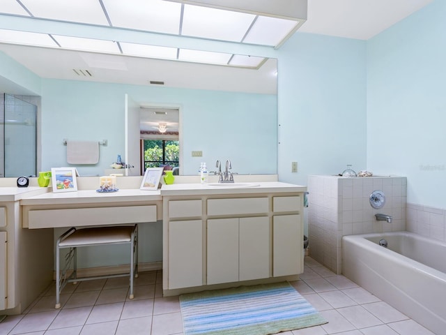 bathroom featuring a tub, vanity, and tile patterned floors