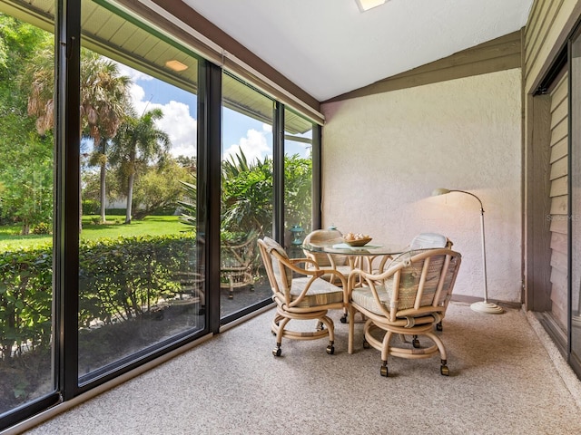 sunroom featuring vaulted ceiling