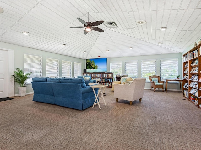 carpeted living room with ceiling fan