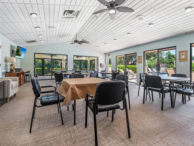 dining space with lofted ceiling, ceiling fan, and carpet