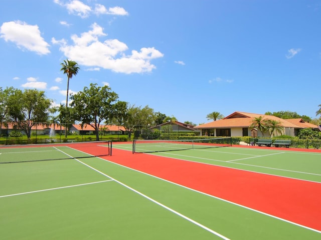 view of tennis court featuring basketball hoop