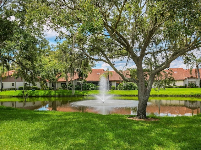 exterior space with a water view and a yard