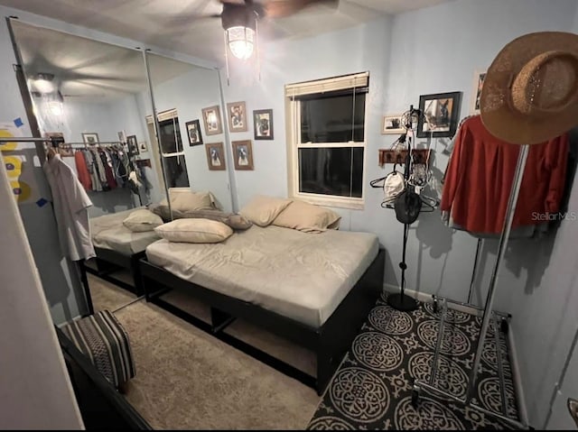 bedroom featuring ceiling fan and baseboards