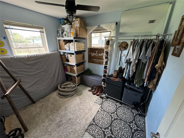 bedroom with ceiling fan, multiple windows, and visible vents