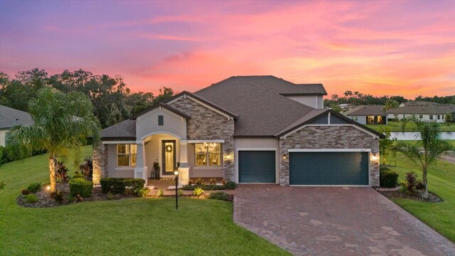 view of front of house with a lawn and a garage