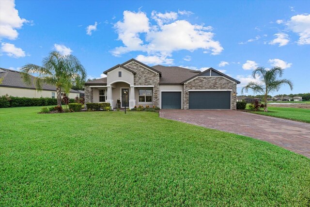 view of front of house with a garage and a front lawn