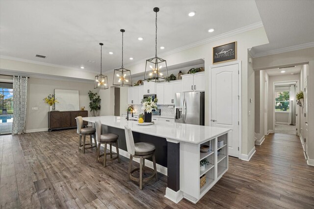 kitchen with pendant lighting, a spacious island, stainless steel fridge with ice dispenser, dark hardwood / wood-style floors, and white cabinetry