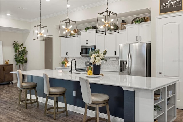 kitchen featuring pendant lighting, a spacious island, dark wood-type flooring, and appliances with stainless steel finishes