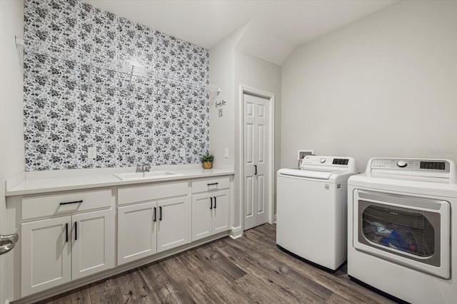 laundry area featuring washer and dryer, cabinets, sink, and dark wood-type flooring