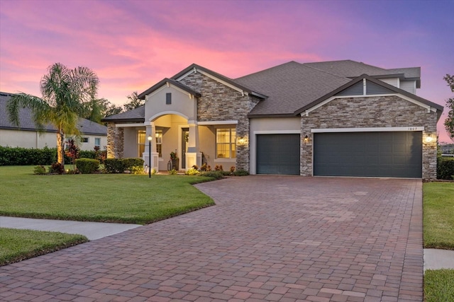 view of front of property featuring a yard and a garage