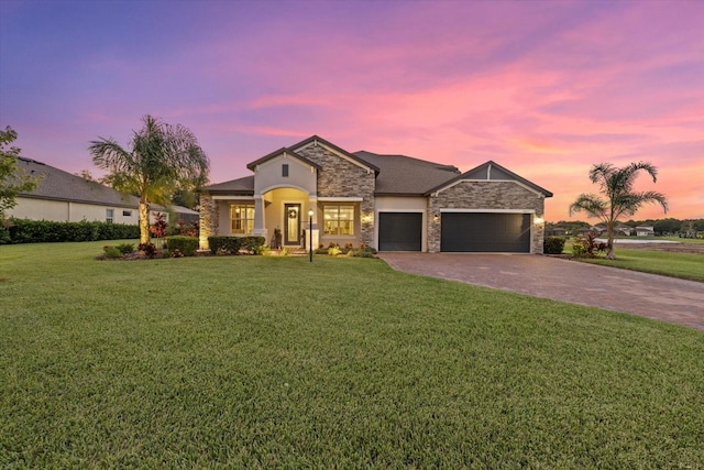 view of front of property with a lawn and a garage