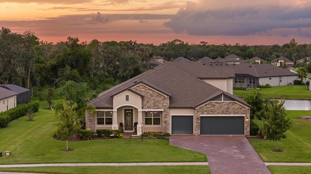 view of front of house featuring a yard and a garage