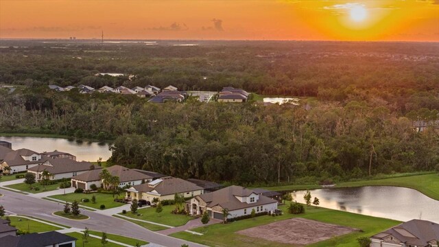 aerial view at dusk with a water view