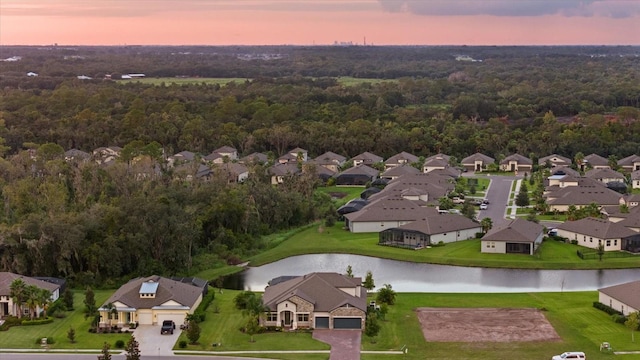 aerial view at dusk with a water view