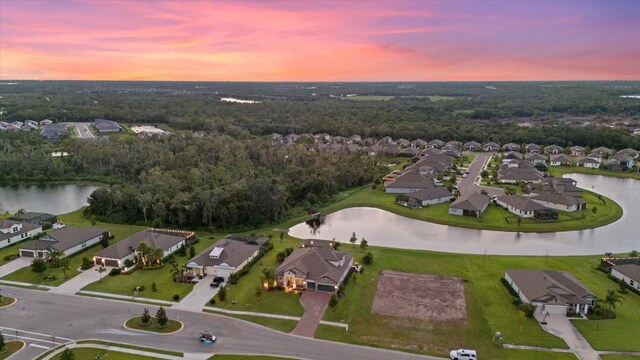 aerial view at dusk with a water view