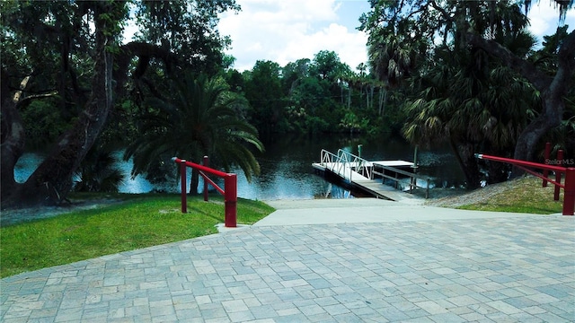 dock area featuring a yard and a water view