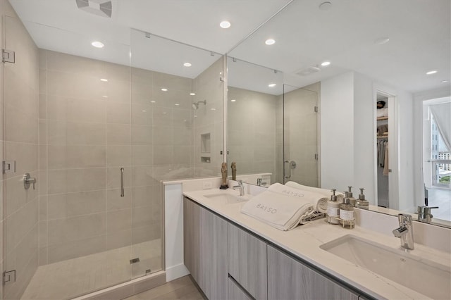 bathroom with hardwood / wood-style floors, vanity, and a shower with shower door