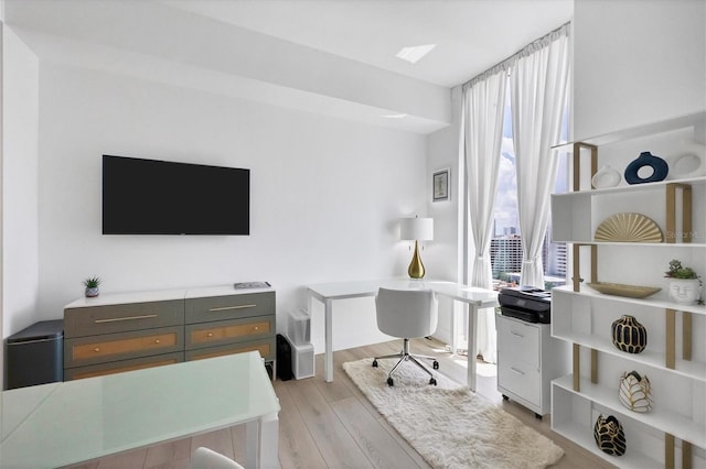 office area with light hardwood / wood-style floors