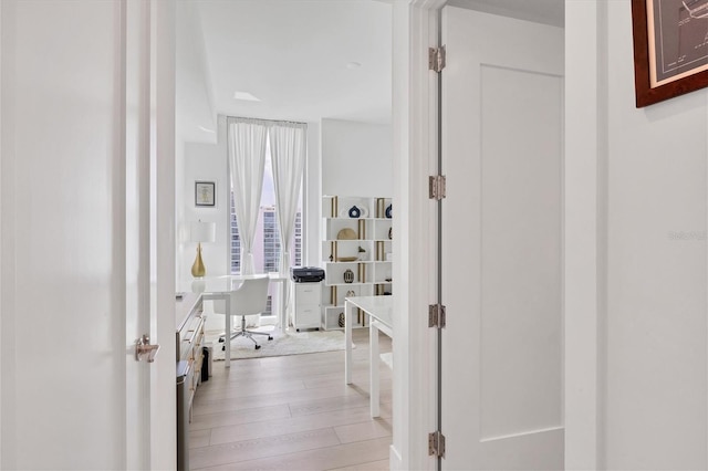 corridor with light hardwood / wood-style floors