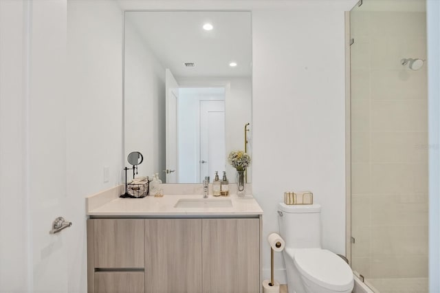 bathroom with vanity, toilet, and an enclosed shower