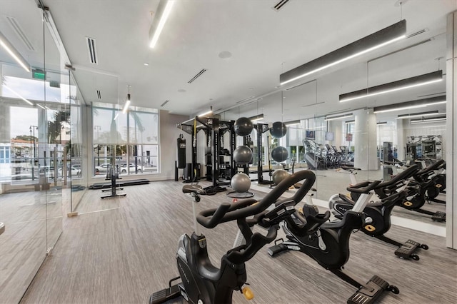 gym with a wall of windows