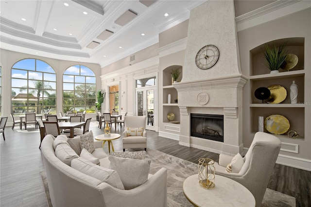 living room featuring a towering ceiling, beamed ceiling, coffered ceiling, built in features, and a high end fireplace