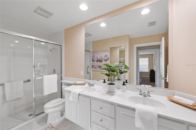 bathroom with toilet, tile patterned floors, an enclosed shower, and vanity