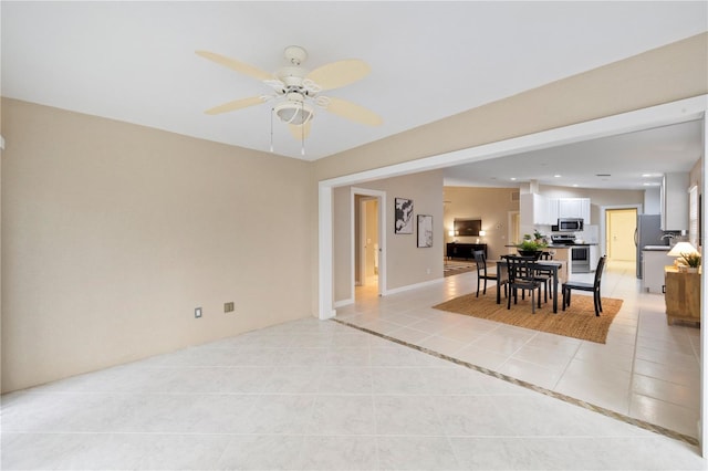 interior space with ceiling fan