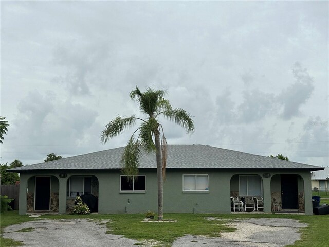 exterior space with covered porch and a yard