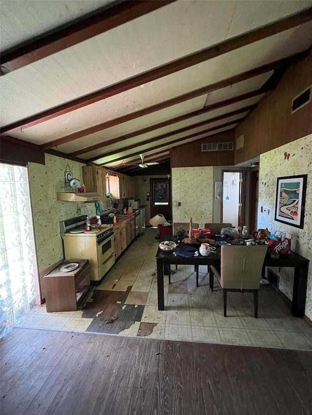 interior space featuring lofted ceiling with beams and hardwood / wood-style flooring